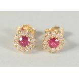 A GOOD PAIR OF 18CT GOLD RUBY AND DIAMOND EARRINGS.