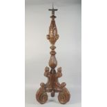 A GOOD 17TH - 18TH CENTURY CARVED AND GILDED ITALIAN PRICKET CANDLESTICK with cupids' heads, on