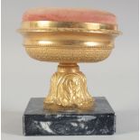 A SQUARE 19TH CENTURY GILDED URN SHAPED PIN CUSHION on a square base. 4ins high.