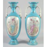 A PAIR OF CONTINENTAL LIGHT BLUE CLASSICAL SCENE VASES AND COVERS. 18ins high.