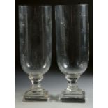 A GOOD PAIR OF SMALL CUT GLASS HURRICANE LAMPS on square bases. 13ins high.