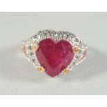 A SILVER AND RUBY HEART RING.