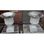 A GOOD PAIR OF CARVED ITALIAN WHITE MARBLE CAMPAGNA URNS ON STANDS. The sides with dancing