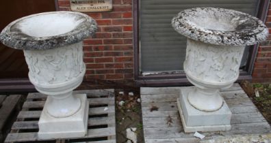 A GOOD PAIR OF CARVED ITALIAN WHITE MARBLE CAMPAGNA URNS ON STANDS. The sides with dancing