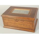 A 19TH CENTURY WOODEN JEWELLERY BOX the lid with a print of a country house. 9.5ins.