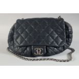 A LARGE NAVY BLUE LEATHER CHANEL PADDED BAG with entwined chrome and leather straps, 21ins long. No.
