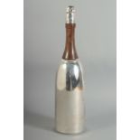 A SILVER PLATED AND WOOD CHAMPAGNE BOTTLE COCKTAIL SHAKER.