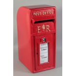 A RED CAST IRON POST BOX.
