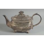 A GEORGE III SILVER TEA POT on four ball feet. London 1814, weight, 19ozs.