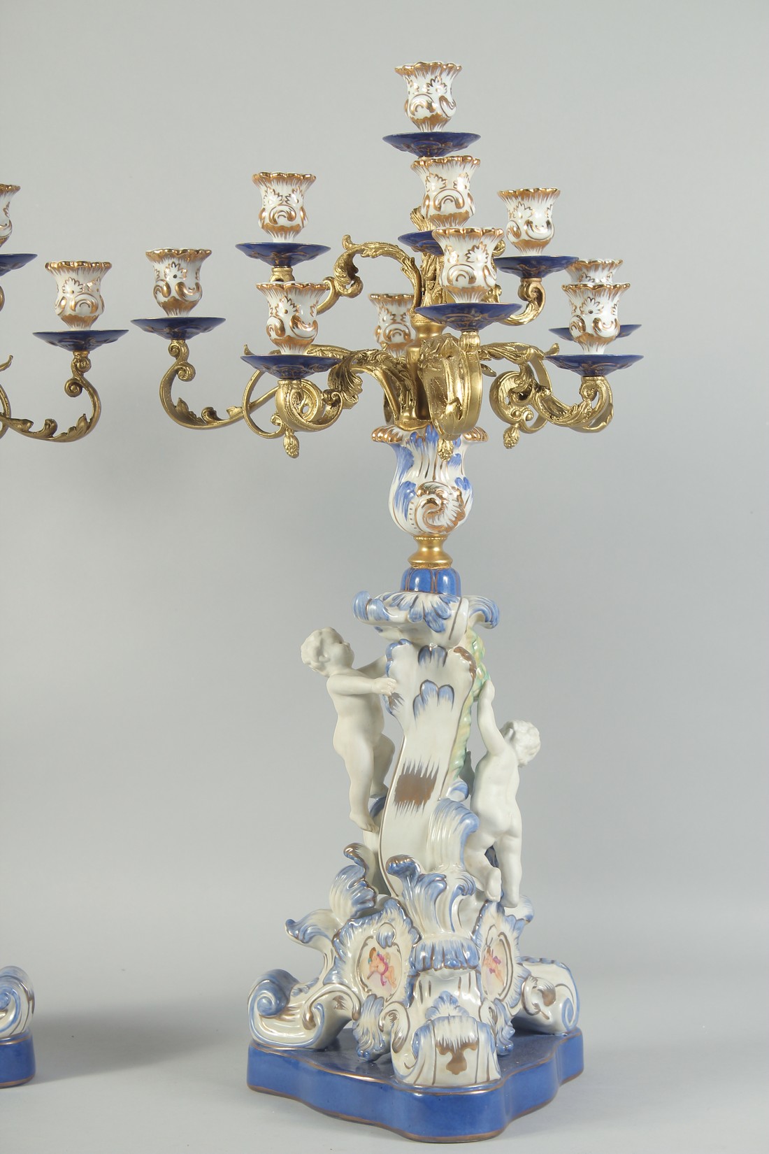 A GOOD PAIR OF SEVRES STYLE EIGHT BRANCH CANDELABRA with cupid support on blue bases. 1ft 11ins - Image 3 of 5