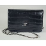 A SMALL CHANEL BLACK LEATHER BAG 18cm long, 12cm wide with long chrome and leather straps, 60cm