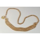 A GOOD LONG CHANEL GILT BELT WITH THREE MEDALLIONS. 5ft long overall.