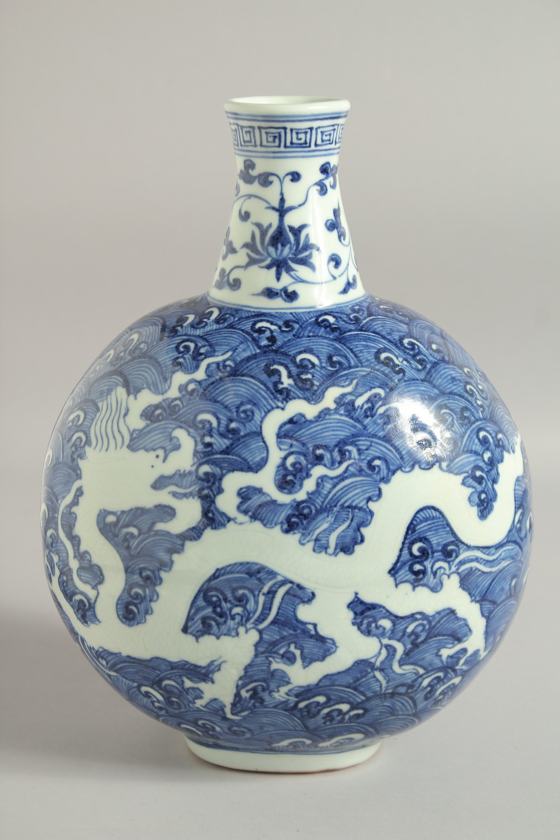 A CHINESE BLUE AND WHITE PORCELAIN MOON FLASK VASE, with incised white dragon on stylised waves, - Image 5 of 6