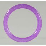 A LAVENDER JADE BANGLE. 7.5ins diameter.