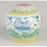 A CHINESE DOUCAI PORCELAIN JAR AND COVER, painted with mythical horses, 12.5cm high.