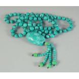 A STRING OF TURQUOISE BEADS plus pendant. 36ins long.