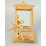 A GILT BRONZE CUPID with a mirror. 8ins high.
