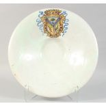 A GOOD 18TH CENTURY POTTERY CIRCULAR ARMORIAL CHARGER with large painted crest. 16ins diameter, 3.