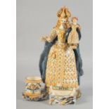 A FRENCH POTTERY FIGURE GROUP, QUEEN HOLDING A DOLL, possibly French. 11.5ins high.