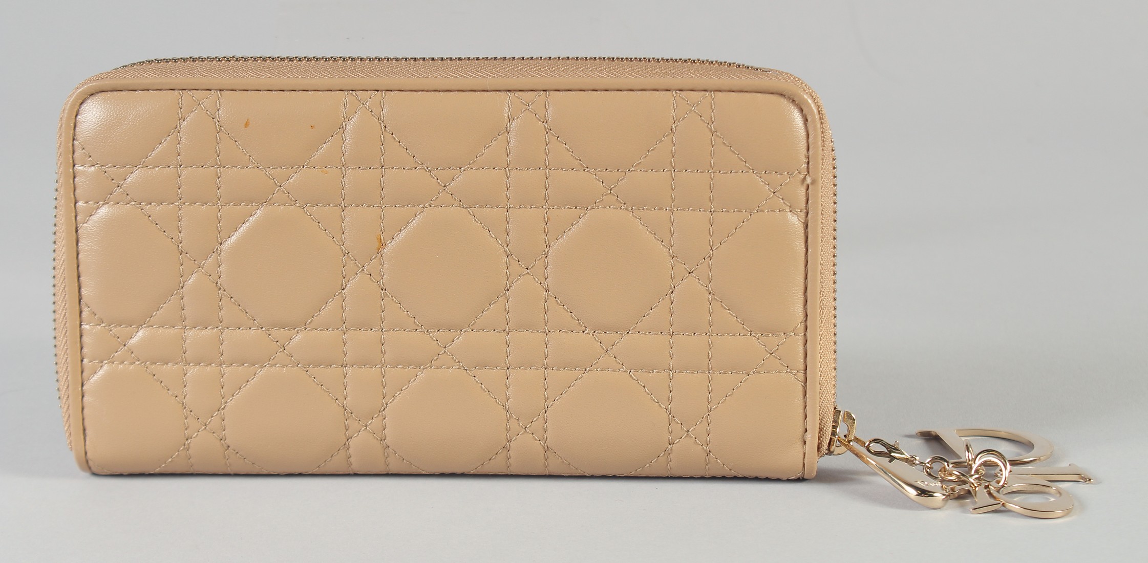 A CHRISTIAN DIOR PADDED PURSE. 20cm long, 11cm high, with a Dior gilt tag, in a dust cover.