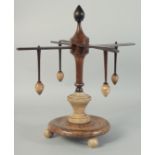 A WOODEN AND ALABASTER WOOL WINDER. 13ins high.