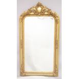 A LARGE GILTWOOD MIRROR. 5ft 2ins high, 2ft 9ins wide.