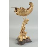 A GOOD GILT BRONZE FIGURE HOLDING A CONCH SHELL with dolphin base. 15ins high.