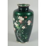 A GOOD JAPANESE GREEN CLOISONNE ENAMEL VASE with flowers. 6ins high.