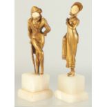DORVAL (CIRCA. 1930) A GOOD PAIR OF GILT BRONZE FIGURES of a young lady and a man with ivory