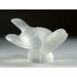 A LALIQUE FROSTED GLASS BIRD, wings closed. Signed, Lalique, France. 5.25ins long.