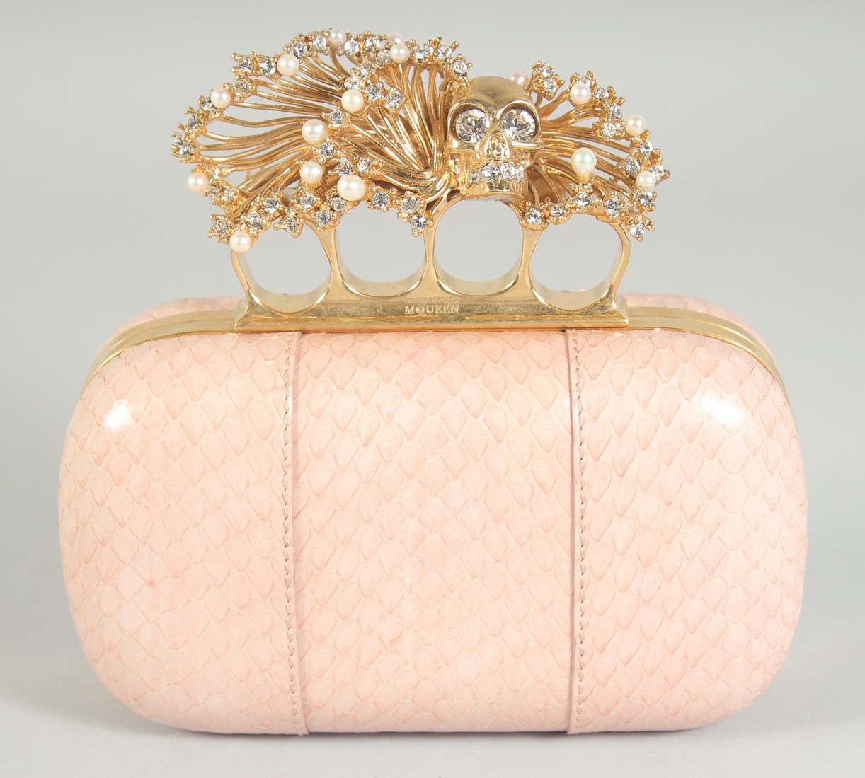 ALEXANDER McQUEEN. A PINK SNAKESKIN SKULL KNUCKLE DUSTER CLUTCH BAG.