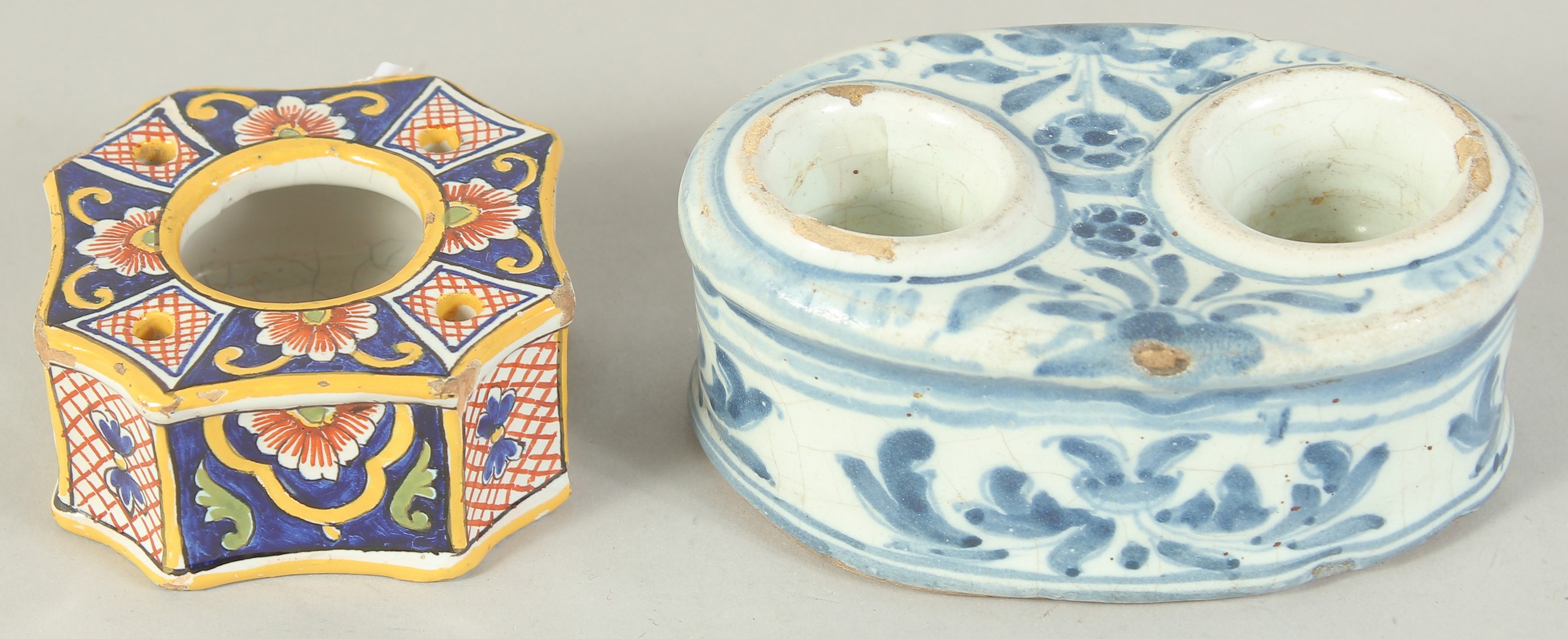 TWO FAIENCE TIN GLAZE INK POTS, one blue and white with two ink pots, the other coloured with one