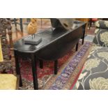 AN EBONISED WAKE TABLE, 20TH CENTURY, the oval drop leaf top on square legs. open size 8ft 5.5ins