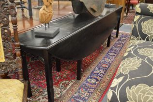 AN EBONISED WAKE TABLE, 20TH CENTURY, the oval drop leaf top on square legs. open size 8ft 5.5ins