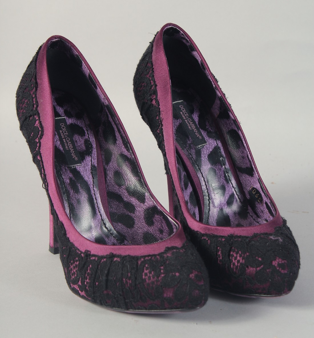 A PAIR OF DOLCE AND GABBANA BLACK AND PURPLE HIGH HEEL SHOES. Size 37.