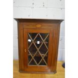 An inlaid mahogany hanging corner display cabinet.