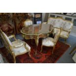 A French style gilt framed and floral upholstered four piece salon suite comprising settee, armchair