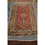 A Persian design rug, pink ground with all-over geometric design 185cm x 118cm.