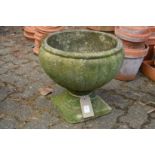 A small pedestal composite garden planter.