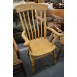 A Victorian style beech high back Windsor armchair.