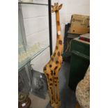 A large carved wood model of a giraffe.