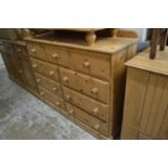 A large pine chest of drawers.