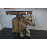 A pair of carved wood gilded and painted elephants stands/tables.