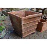 A very large square shaped terracotta plant pot (rim damaged).