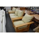 In the manner of Gustav Stickley, an oak framed three piece lounge suite comprising pair of two