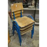 A set of four childrens stacking chairs.