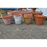 Four large terracotta plant pots.