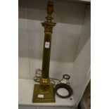 A brass corinthian column table lamp.