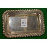 A small rectangular silver tray with gadrooned border.