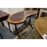 A Victorian walnut and leather inset kidney shaped writing table.